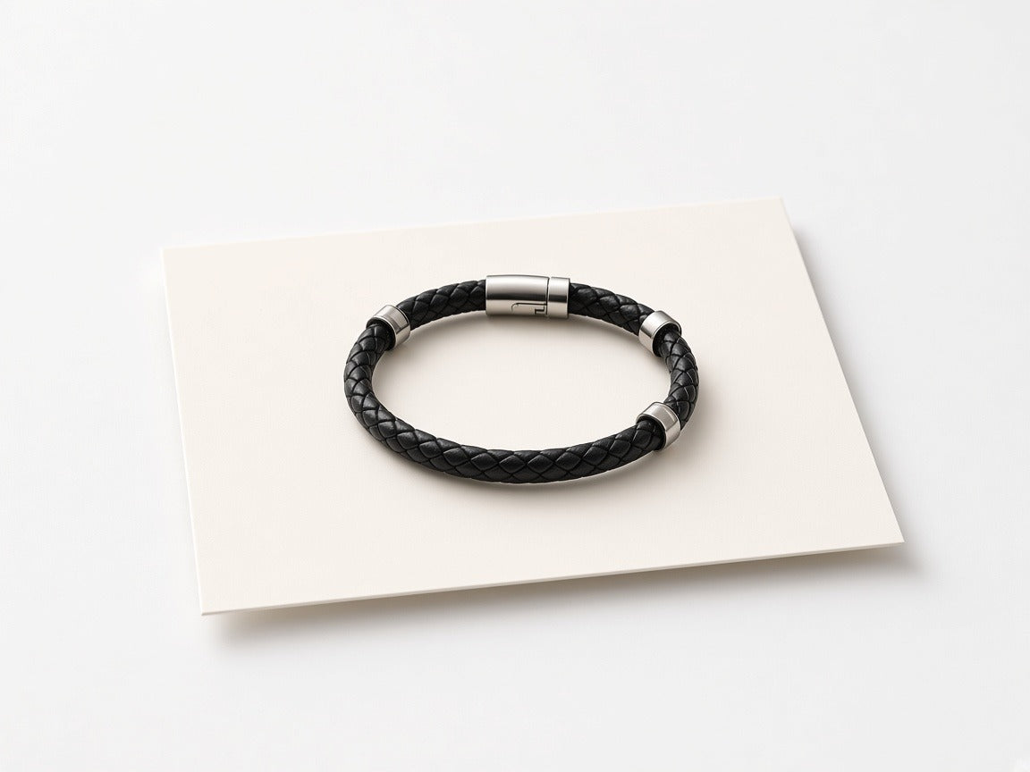 Men's bracelet resting on a plain ivory gift card